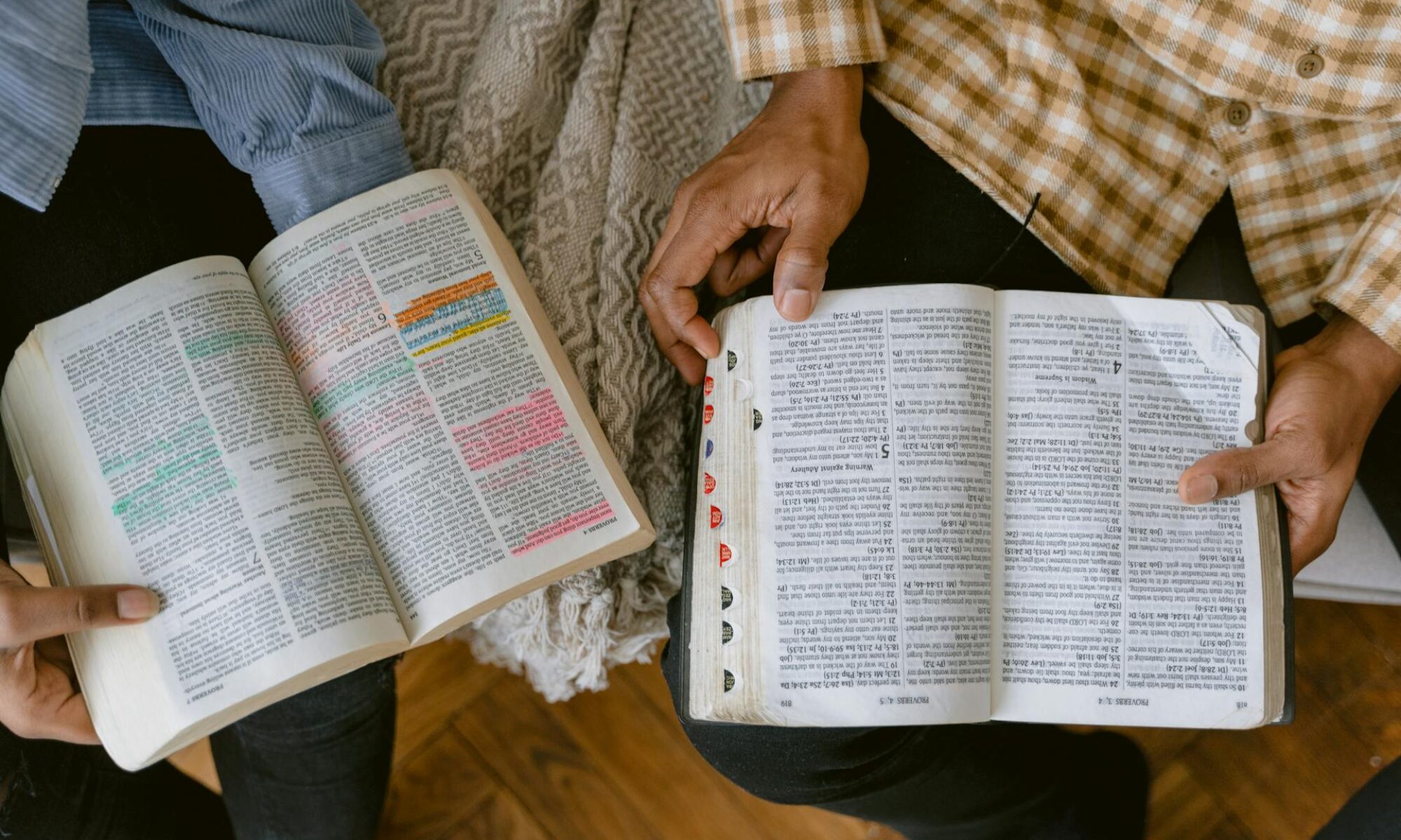 2 people holding open Bibles